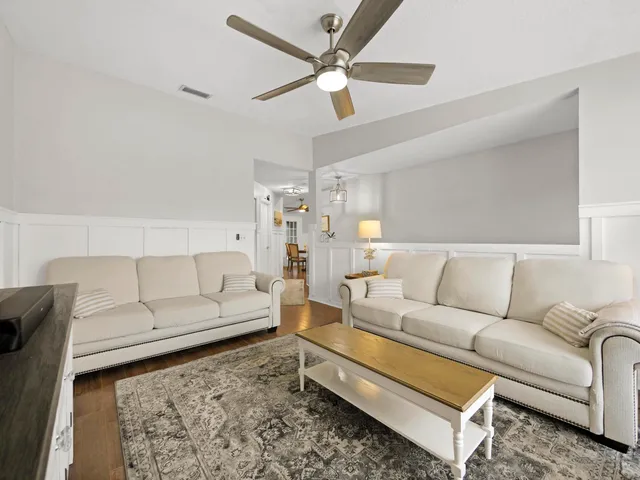 a living room with furniture and a rug