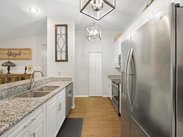 a kitchen with granite countertop a sink and a window