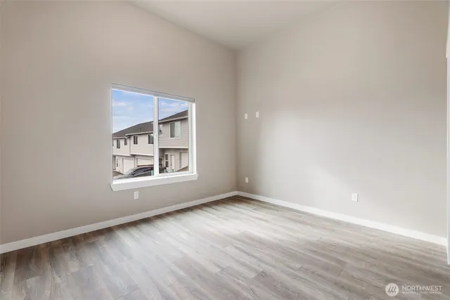 an empty room with closet and wooden floor