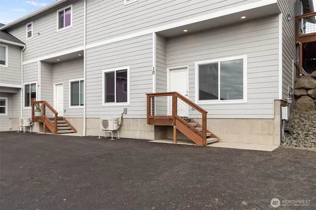 a house with a barbeque and view of a house