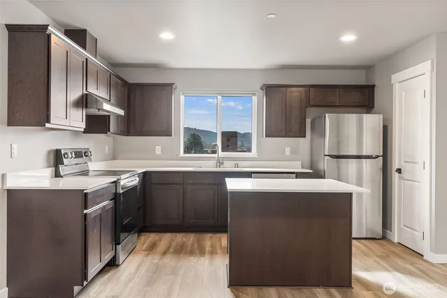 a kitchen with a sink stove and cabinets