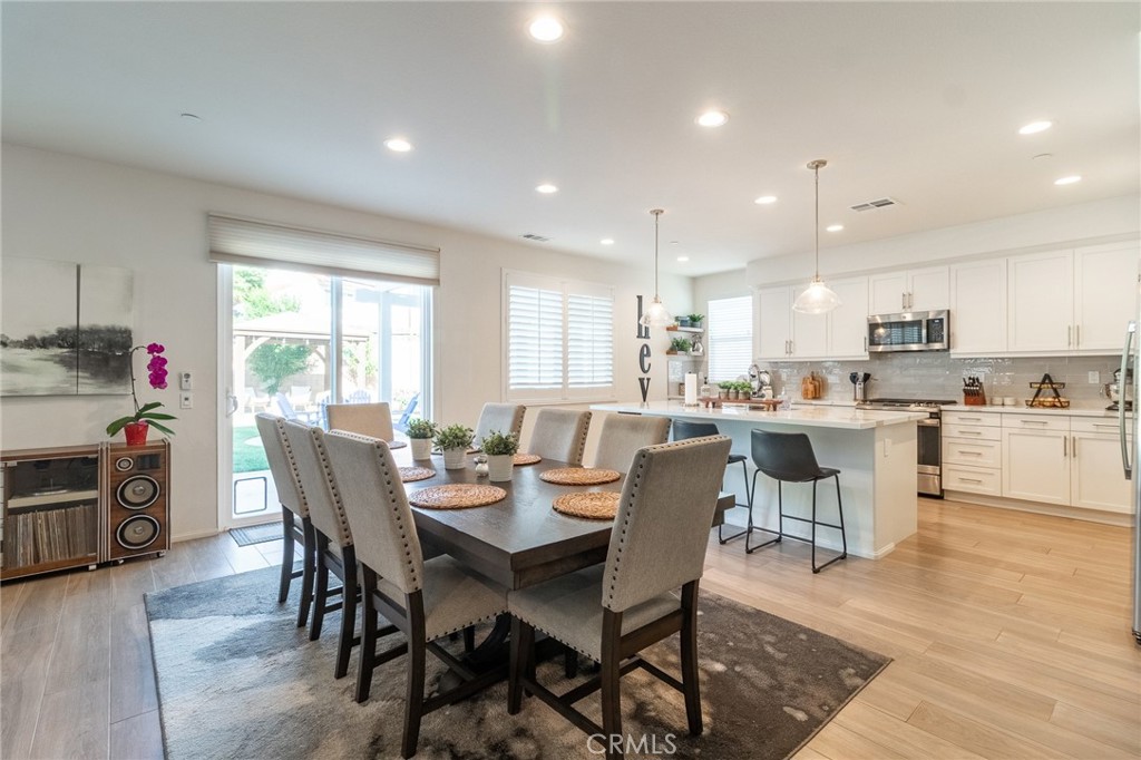 1827 Montecito Lane Redlands, CA 92374 - Photo 12 of 60 a view of a dining room with furniture and wooden floor