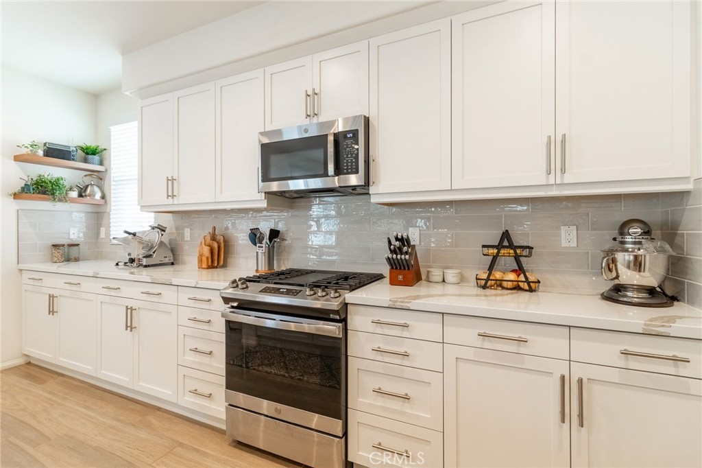 1827 Montecito Lane Redlands, CA 92374 - Photo 18 of 60 a kitchen with white cabinets and appliances