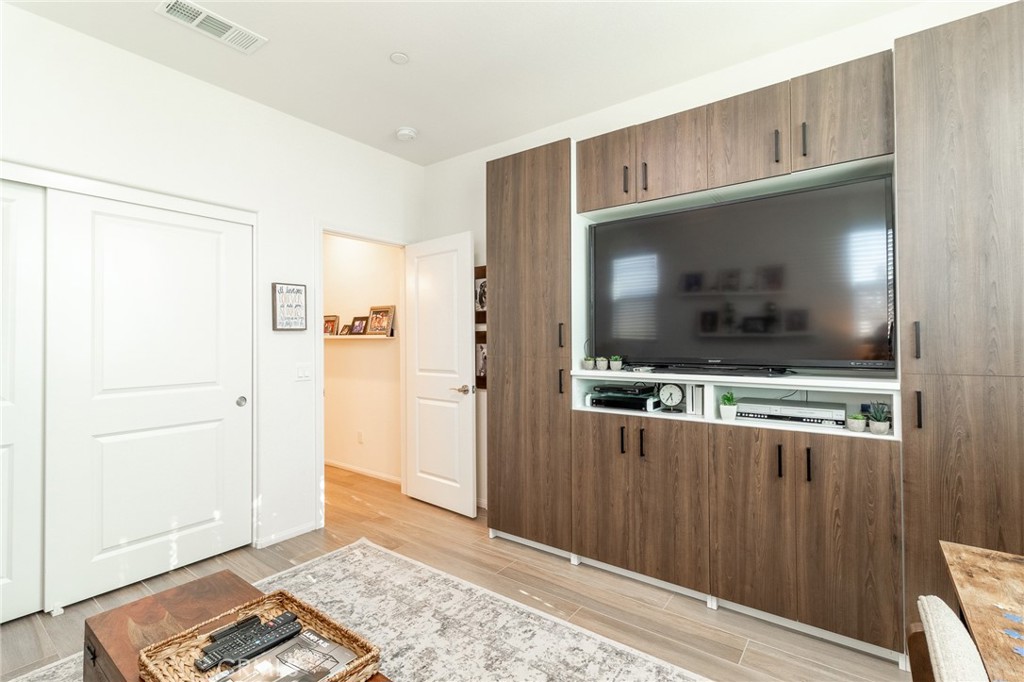 1827 Montecito Lane Redlands, CA 92374 - Photo 22 of 60 a living room with a flat screen tv and a wooden floor