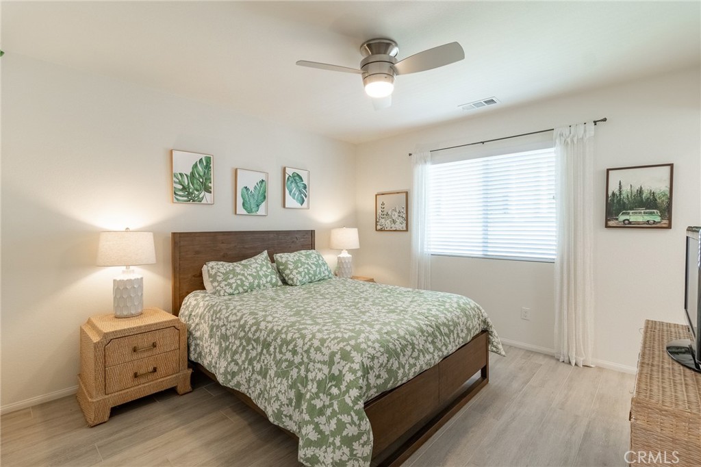 1827 Montecito Lane Redlands, CA 92374 - Photo 32 of 60 a bedroom with a bed and wooden floor