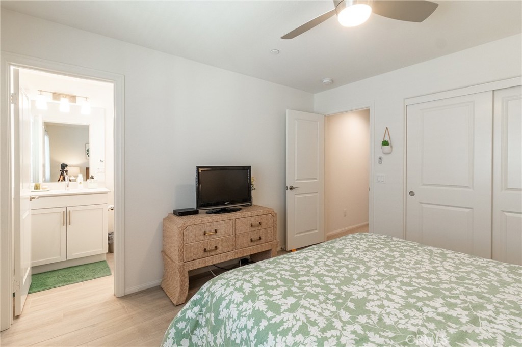 1827 Montecito Lane Redlands, CA 92374 - Photo 33 of 60 a bedroom with a bed and a flat tv screen on wall