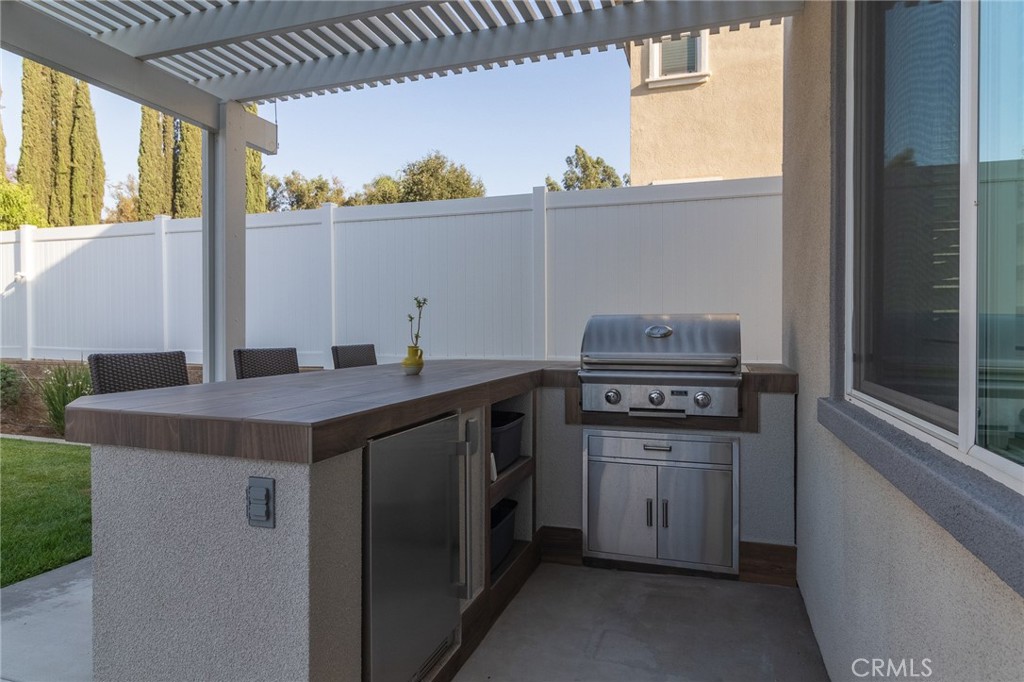 1827 Montecito Lane Redlands, CA 92374 - Photo 47 of 60 a kitchen with a stove a sink and a refrigerator
