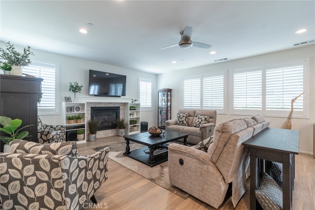 1827 Montecito Lane Redlands, CA 92374 - Photo 9 of 60 a living room with furniture a fireplace and a flat screen tv