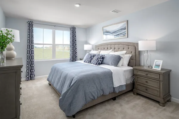 a spacious bedroom with a bed and window