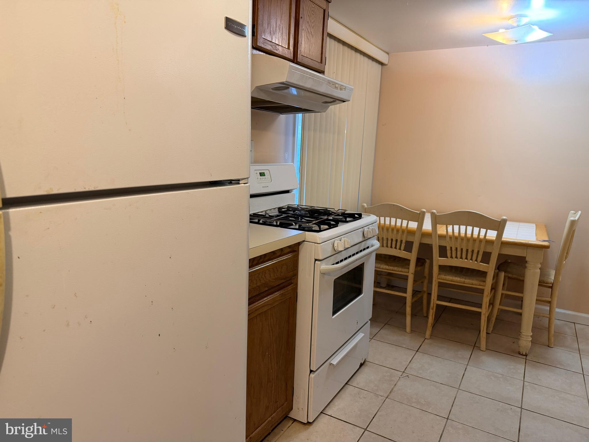 5247 West Running Brook Road, Unit 102 Columbia, MD 21044 - Photo 11 of 28 a kitchen with a stove and a refrigerator