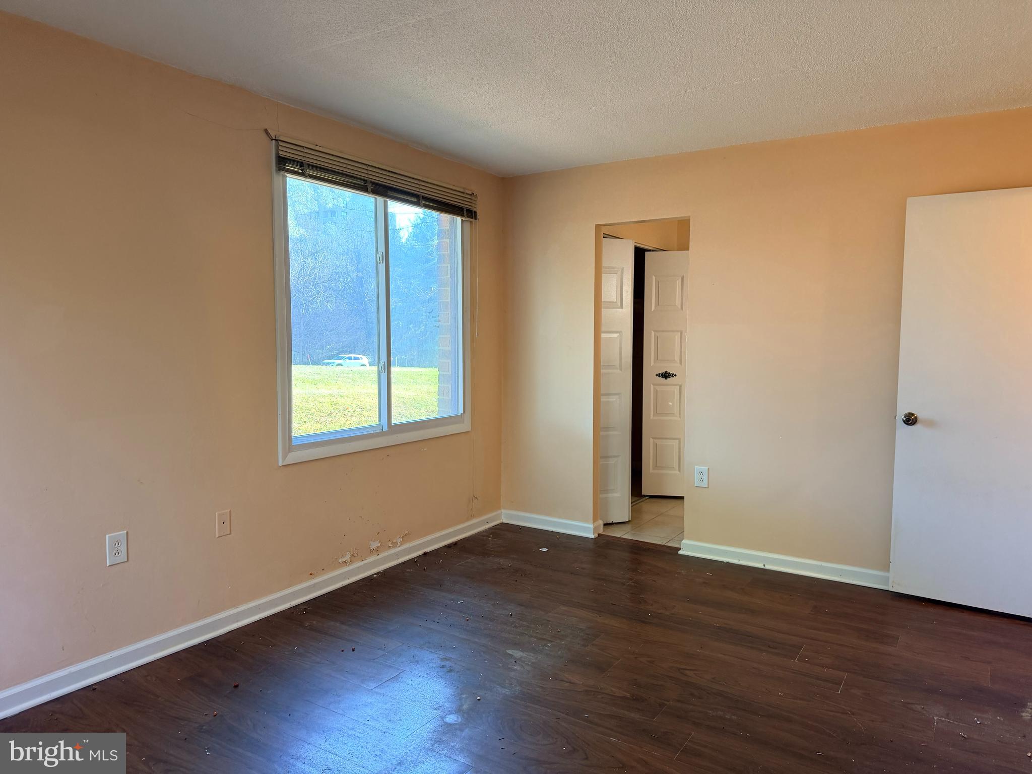 5247 West Running Brook Road, Unit 102 Columbia, MD 21044 - Photo 14 of 28 an empty room with wooden floor and windows