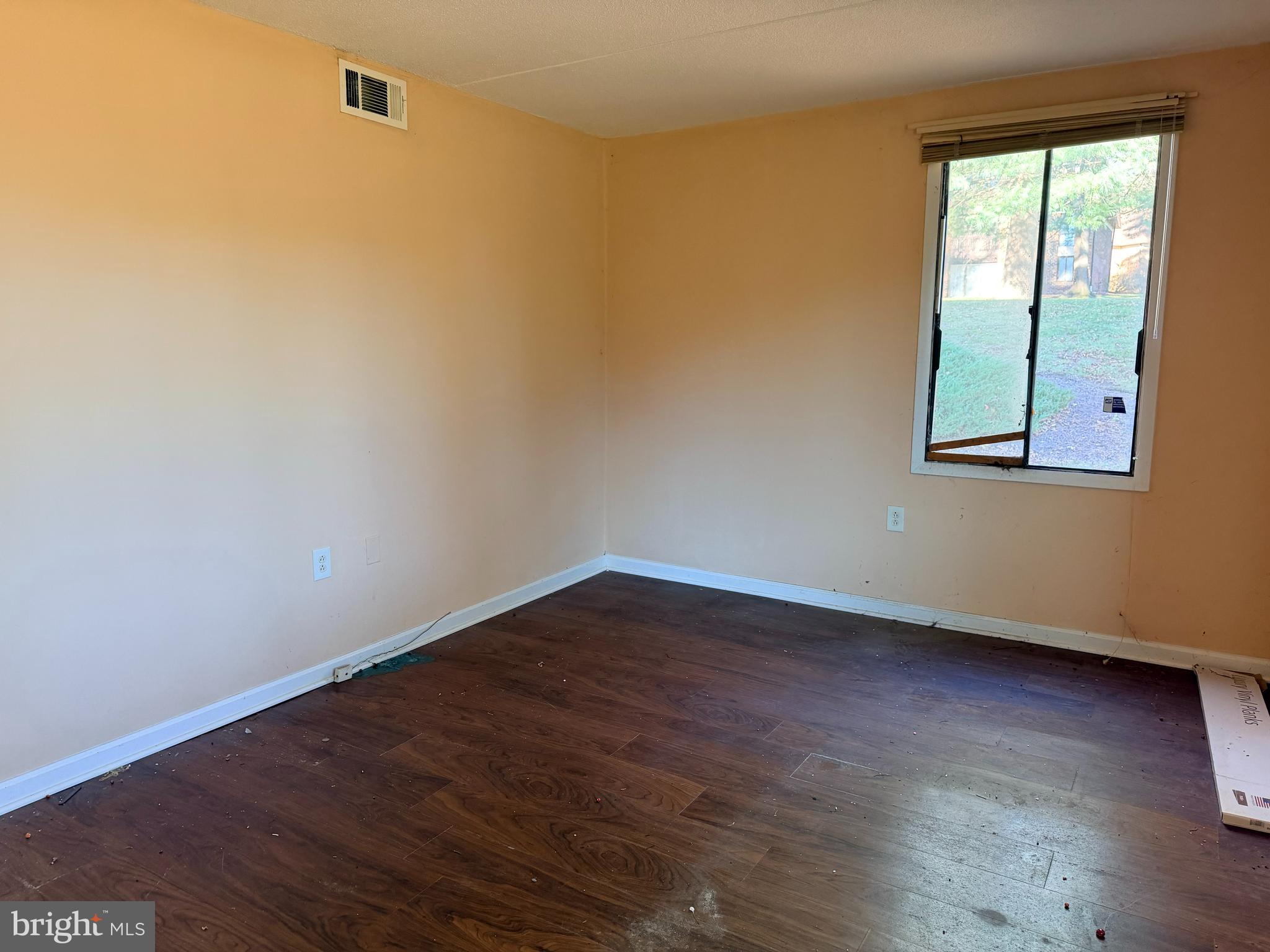 5247 West Running Brook Road, Unit 102 Columbia, MD 21044 - Photo 16 of 28 an empty room with wooden floor and windows