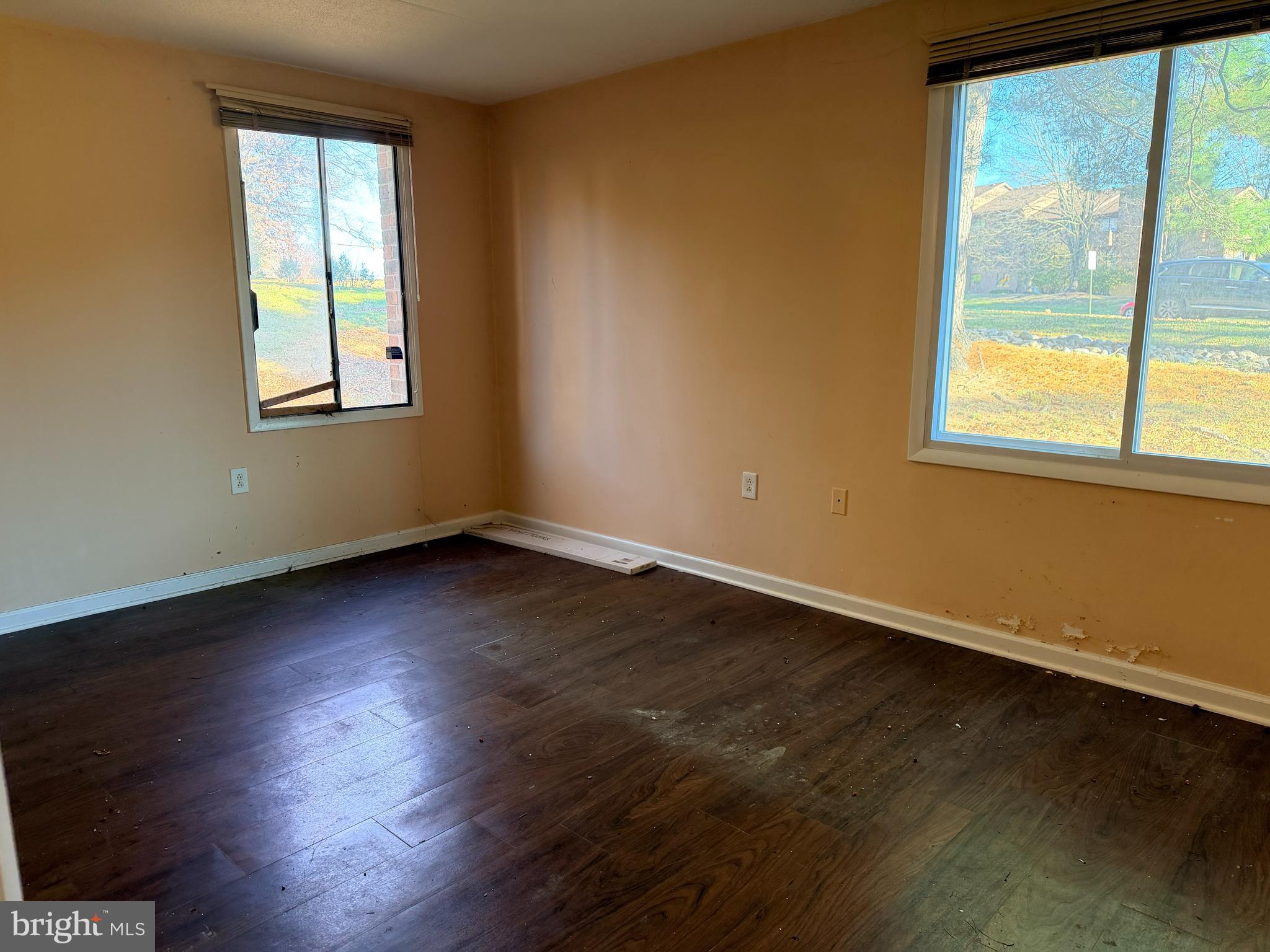 5247 West Running Brook Road, Unit 102 Columbia, MD 21044 - Photo 17 of 28 an empty room with wooden floor and windows