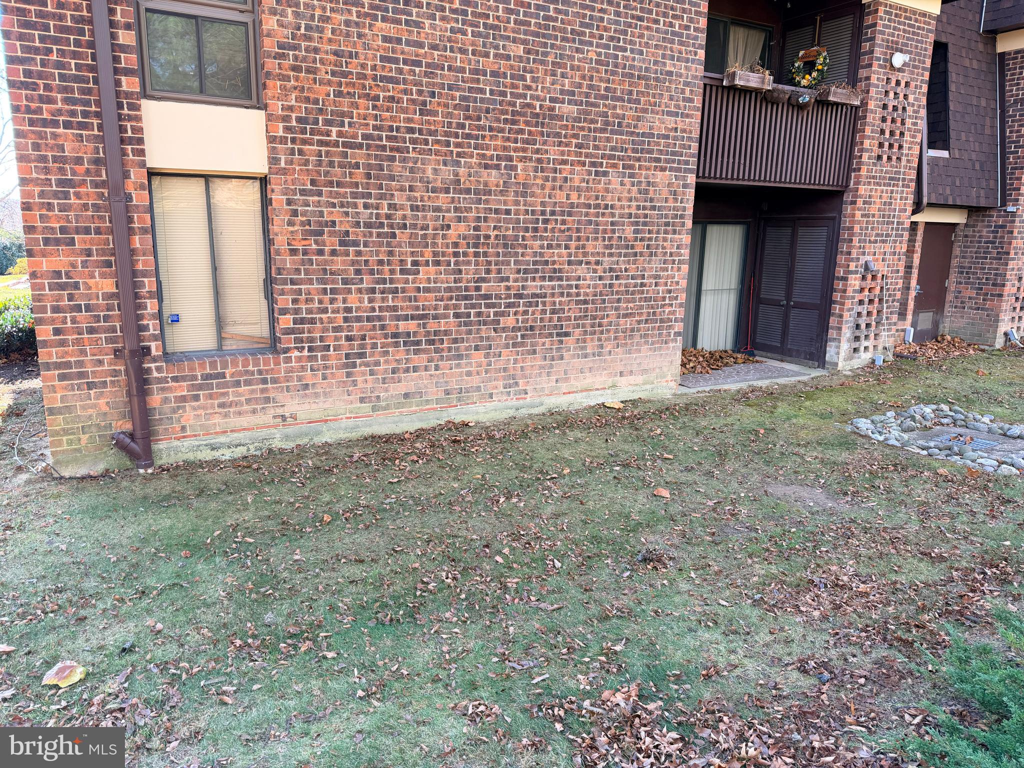 5247 West Running Brook Road, Unit 102 Columbia, MD 21044 - Photo 25 of 28 a view of a brick house with many windows