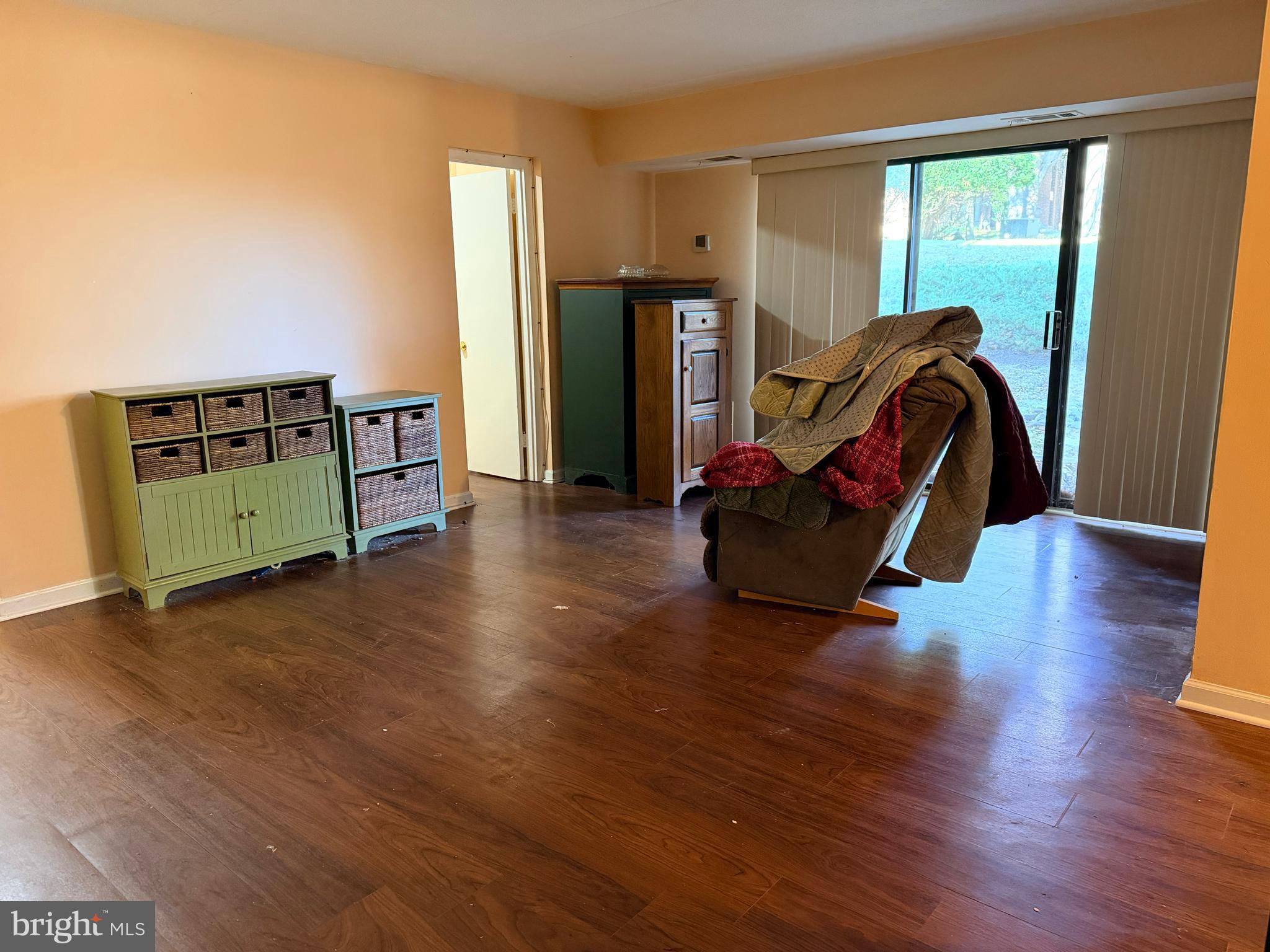5247 West Running Brook Road, Unit 102 Columbia, MD 21044 - Photo 7 of 28 a living room with furniture and a wooden floor
