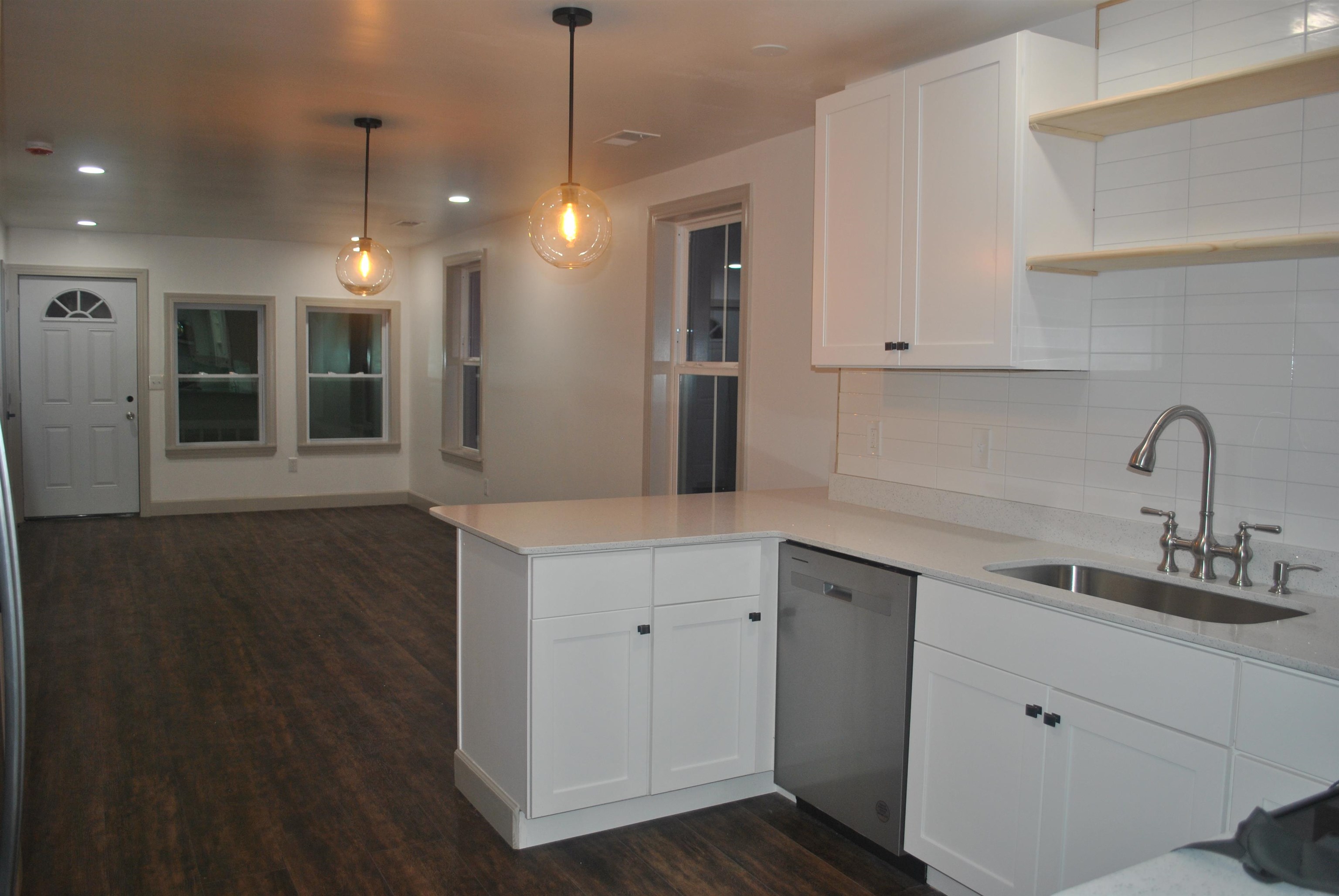 815 North Congdon Street Georgetown, SC 29440 - Photo 12 of 28 Kitchen with dishwasher, white cabinets, decorative backsplash, dark wood-style floors, and recessed lighting