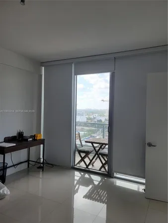 a living room with furniture and a floor to ceiling window
