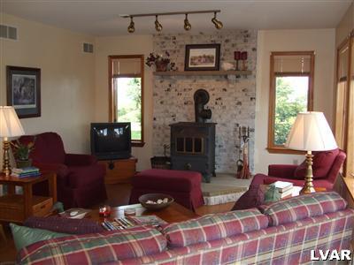 181 Nolf Road Nazareth, PA 18064 - Photo 8 of 19 a living room with furniture a fireplace and a flat screen tv