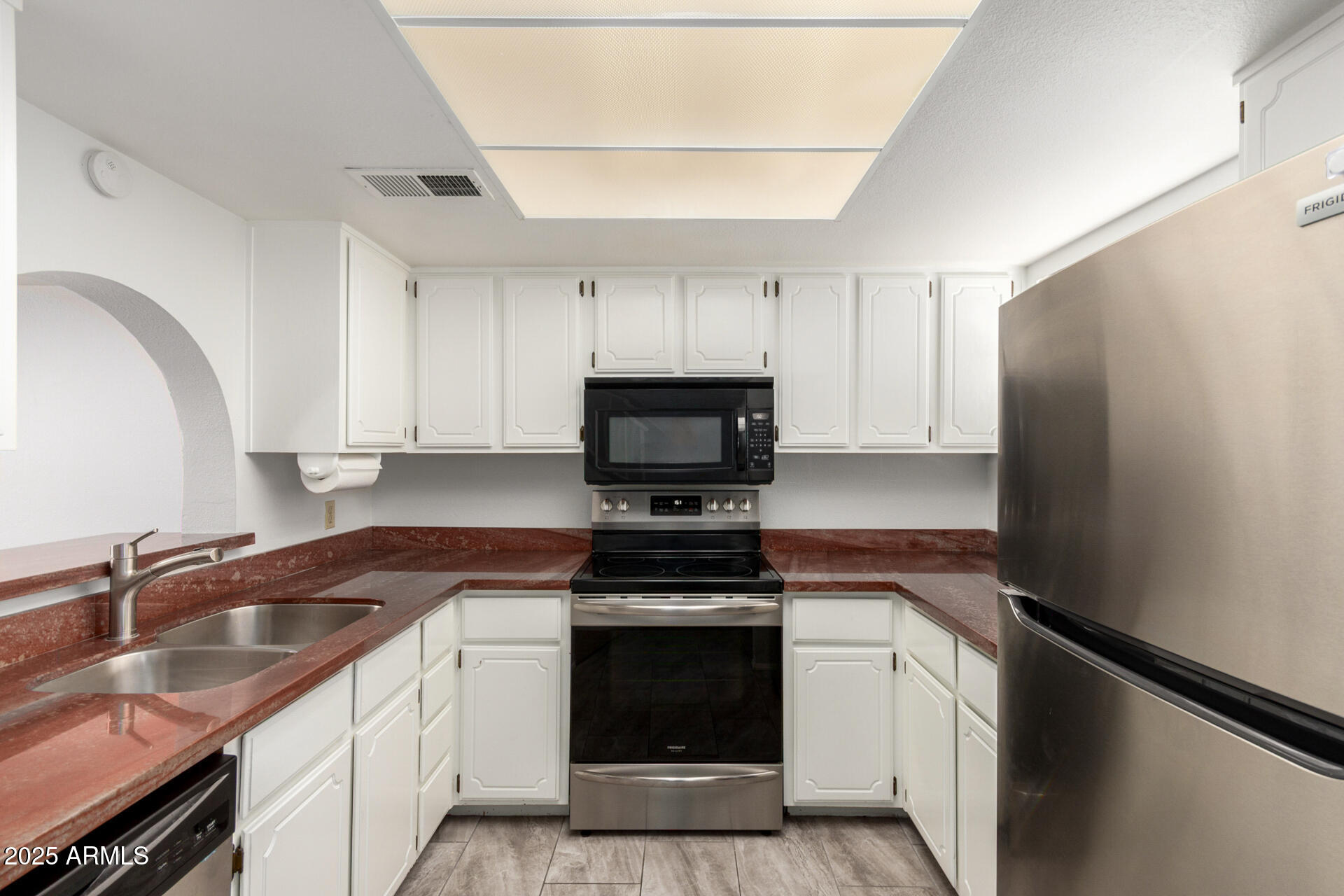 622 West 14th Street Tempe, AZ 85281 - Photo 5 of 18 a kitchen with granite countertop white cabinets and stainless steel appliances