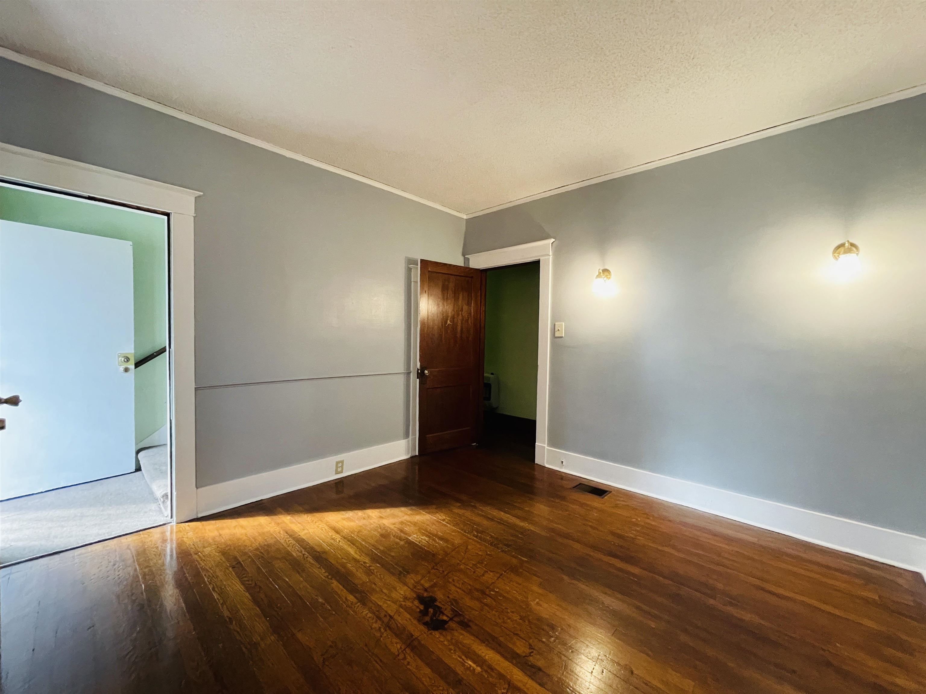 1009 Rozelle Street Memphis, TN 38114 - Photo 25 of 40 Unfurnished room with dark hardwood / wood-style flooring and crown molding