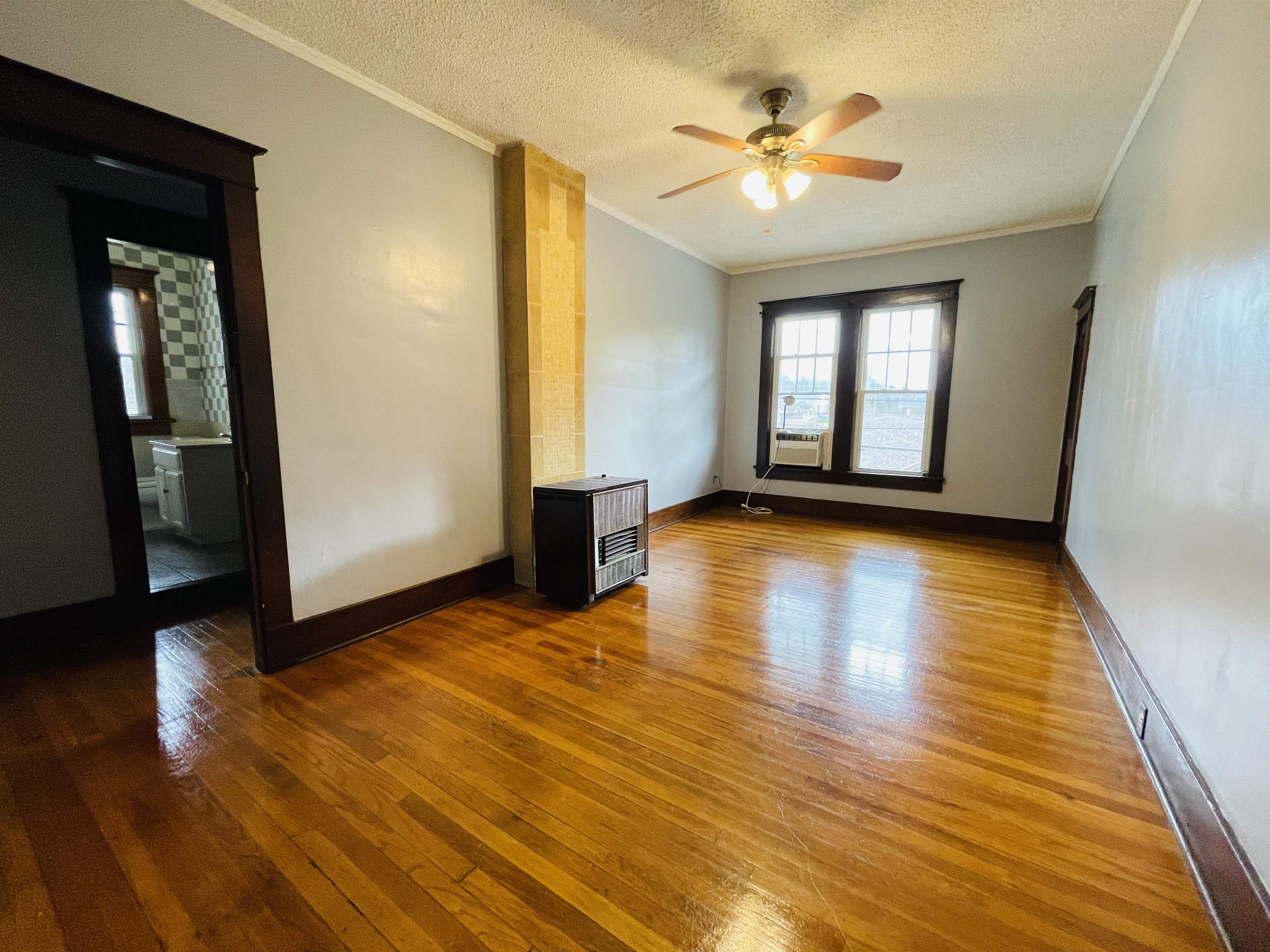 1009 Rozelle Street Memphis, TN 38114 - Photo 29 of 40 Unfurnished room featuring ceiling fan, crown molding, wood-type flooring, and a textured ceiling