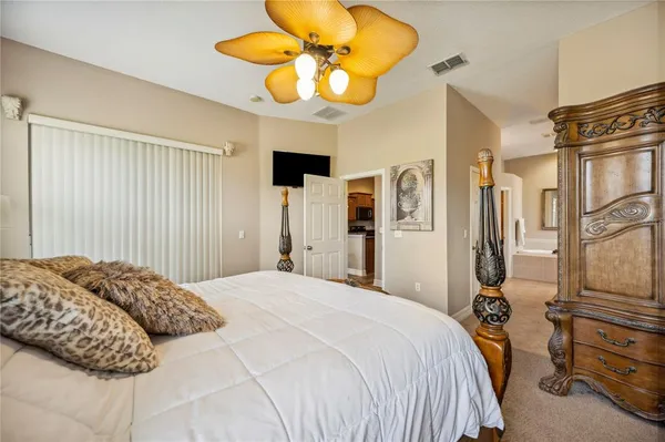 a bedroom with a bed and ceiling fan