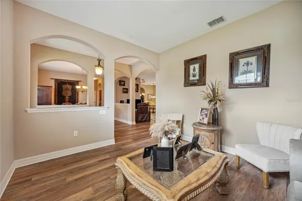 a living room with furniture and wooden floor