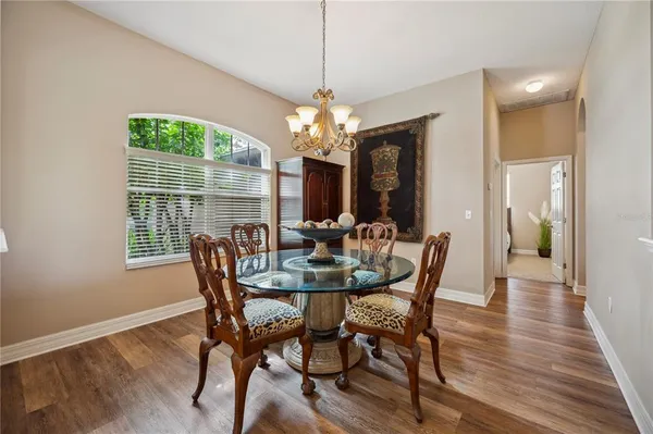 a view of a dining room with furniture wooden floor and chandelier