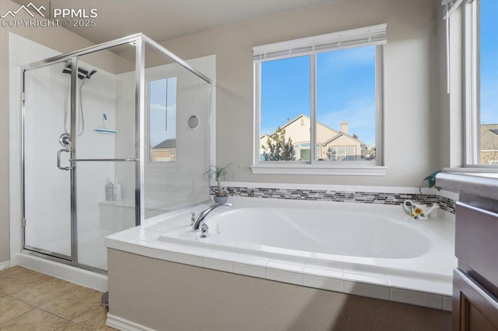 2374 Cinnabar Road Colorado Springs, CO 80921 - Photo 32 of 47 The primary bath has a large shower and a separate soaking tub with private views out the second-story windows.