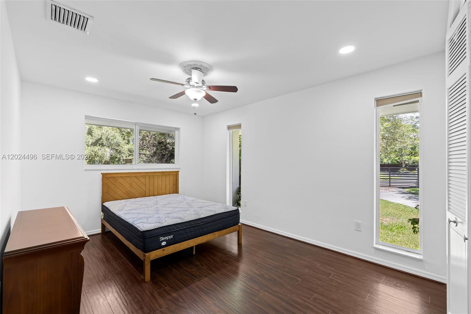 6875 North Cartee Road Palmetto Bay, FL 33158 - Photo 27 of 42 a living room with wooden floor and a window