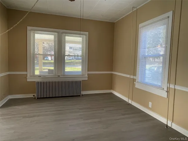 a kitchen with stainless steel appliances granite countertop a dining table chairs refrigerator and sink