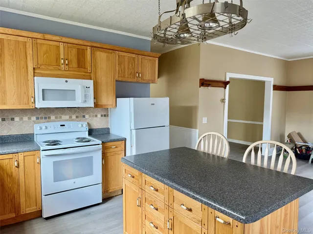 a kitchen with stainless steel appliances granite countertop a sink a counter space and cabinets
