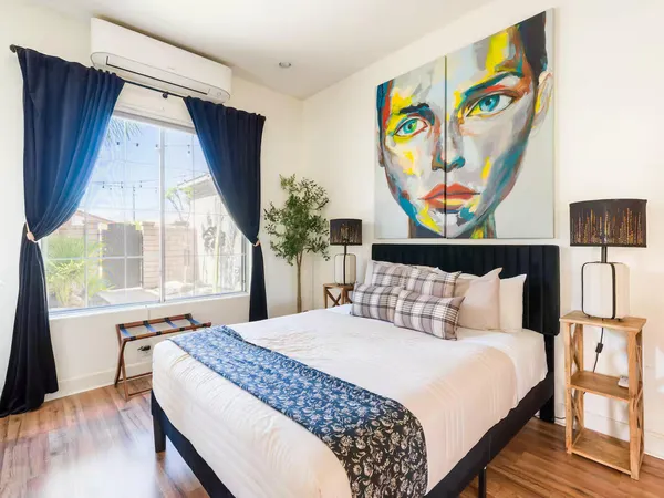 a bedroom with a bed and a window