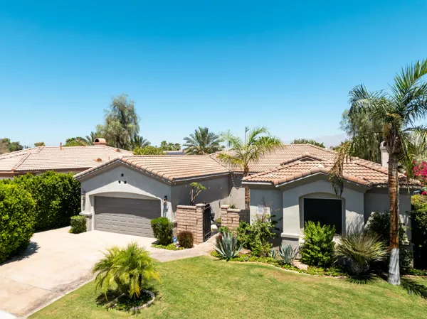 a front view of a house with a yard garage and outdoor seating