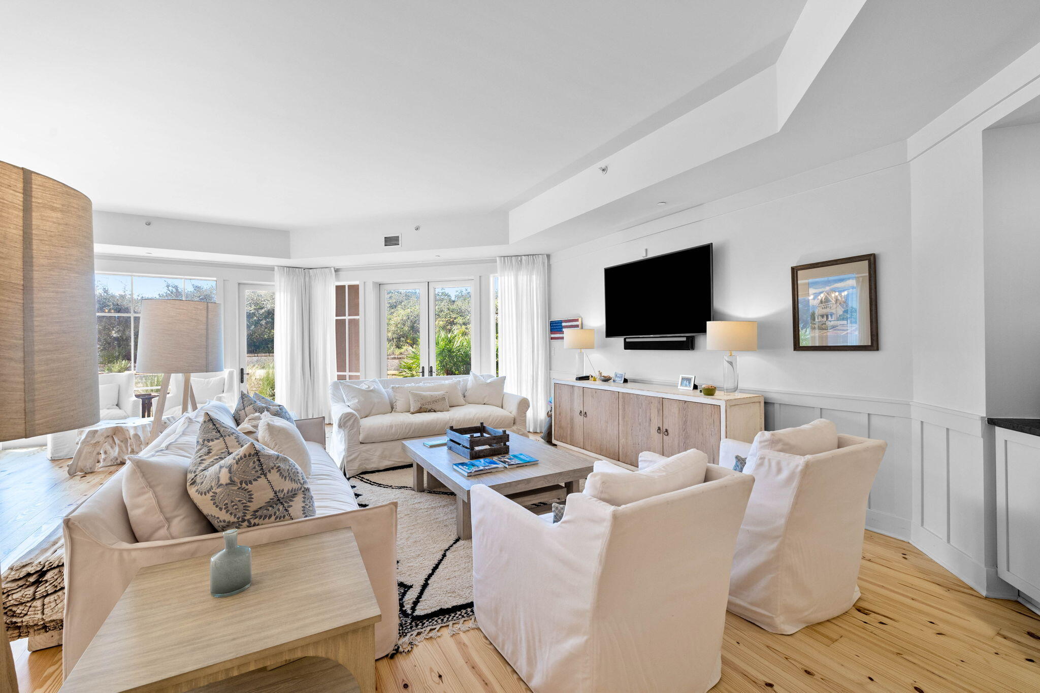 37 Compass Point Way South, Unit 107 Inlet Beach, FL 32461 - Photo 14 of 40 a living room with furniture a flat screen tv and a floor to ceiling window