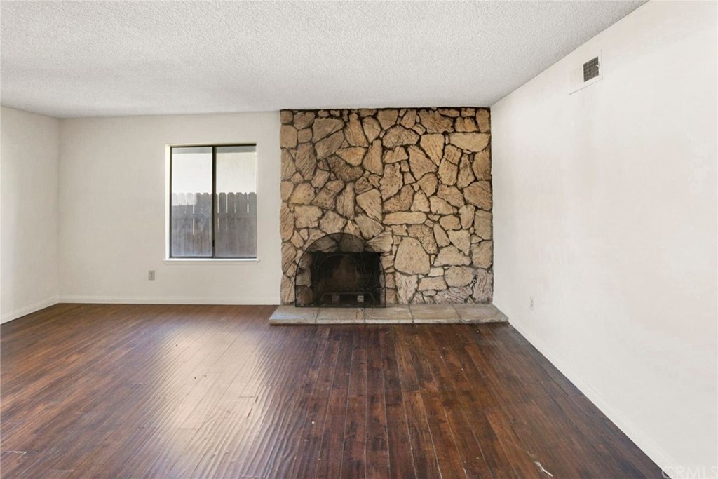 340 Maravilla Drive Riverside, CA 92507 - Photo 19 of 35 a view of an empty room with wooden floor and a window