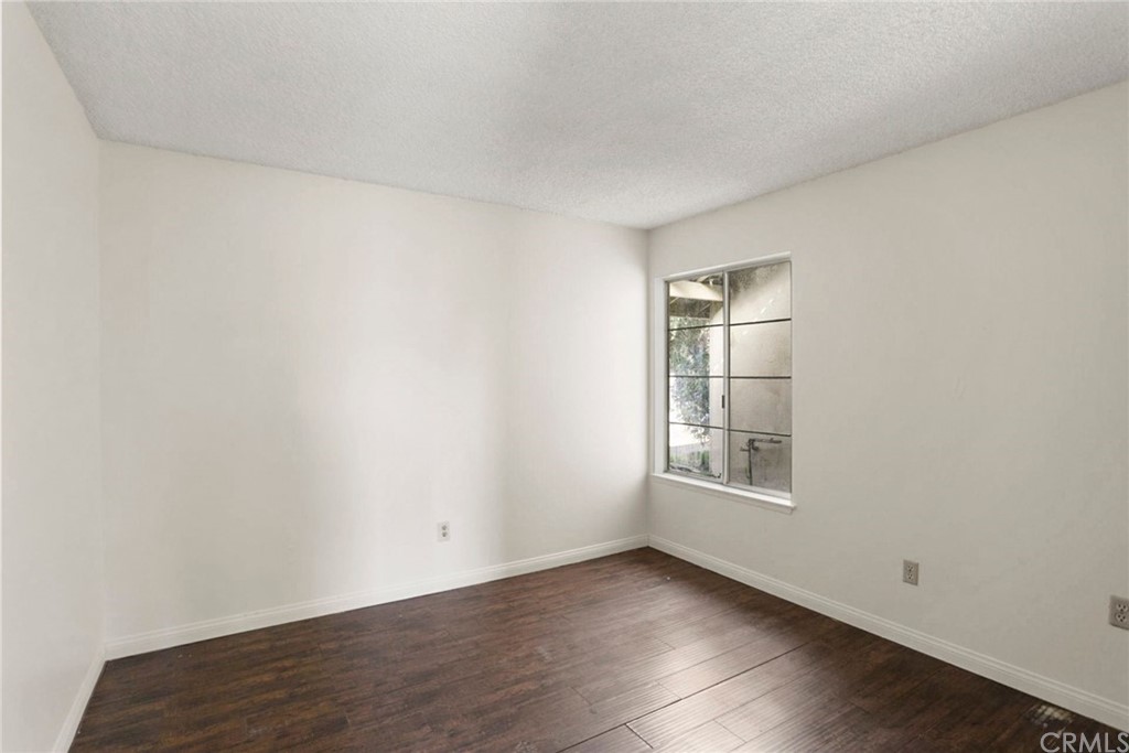 340 Maravilla Drive Riverside, CA 92507 - Photo 26 of 35 an empty room with wooden floor and windows