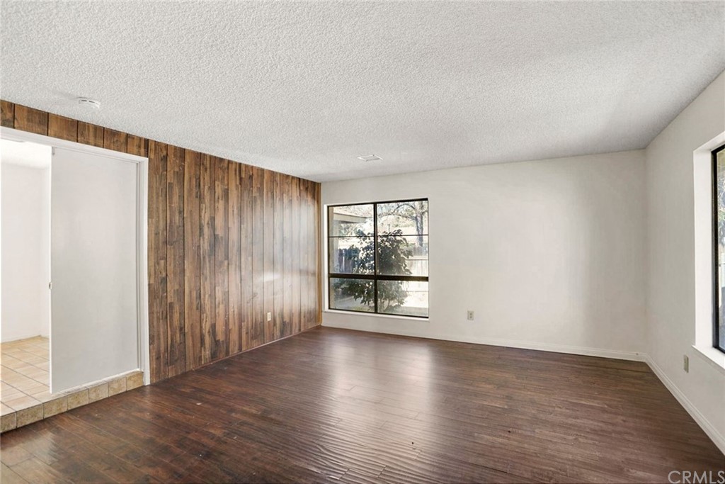 340 Maravilla Drive Riverside, CA 92507 - Photo 27 of 35 an empty room with wooden floor and windows