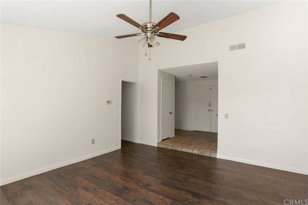 340 Maravilla Drive Riverside, CA 92507 - Photo 7 of 35 an empty room with wooden floor and ceiling fan