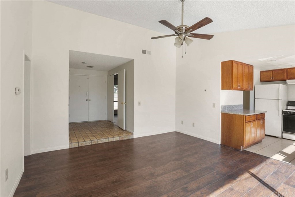 340 Maravilla Drive Riverside, CA 92507 - Photo 10 of 35 an empty room with wooden floor and a ceiling fan