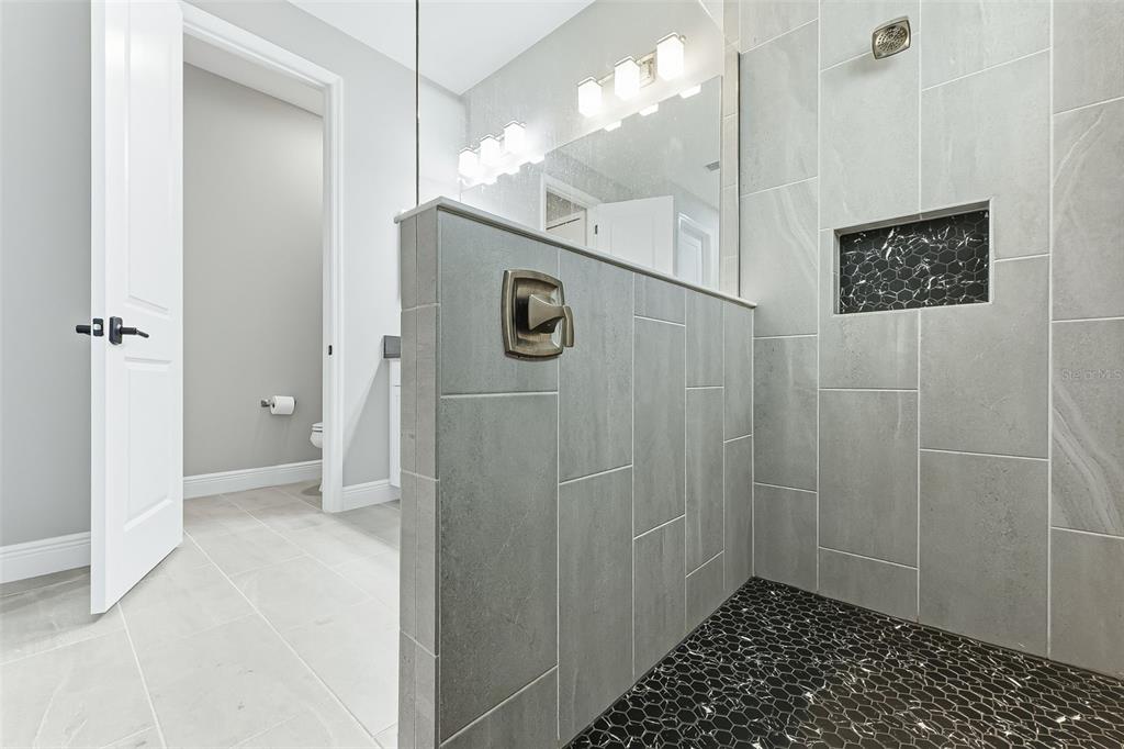 4191 Pegasus Way Naples, FL 34120 - Photo 22 of 48 a bathroom with a shower and a sink