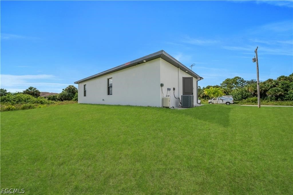 711 Roma Avenue South Lehigh Acres, FL 33974 - Photo 25 of 38 a view of a house with a yard