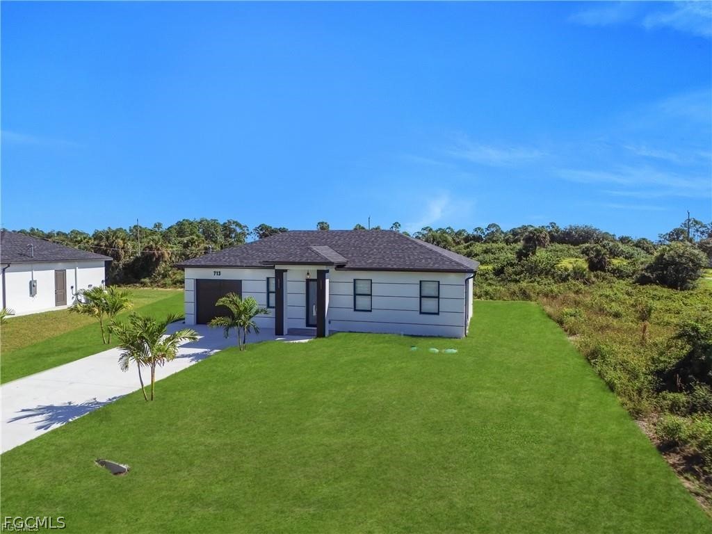 711 Roma Avenue South Lehigh Acres, FL 33974 - Photo 29 of 38 a view of a house with a big yard
