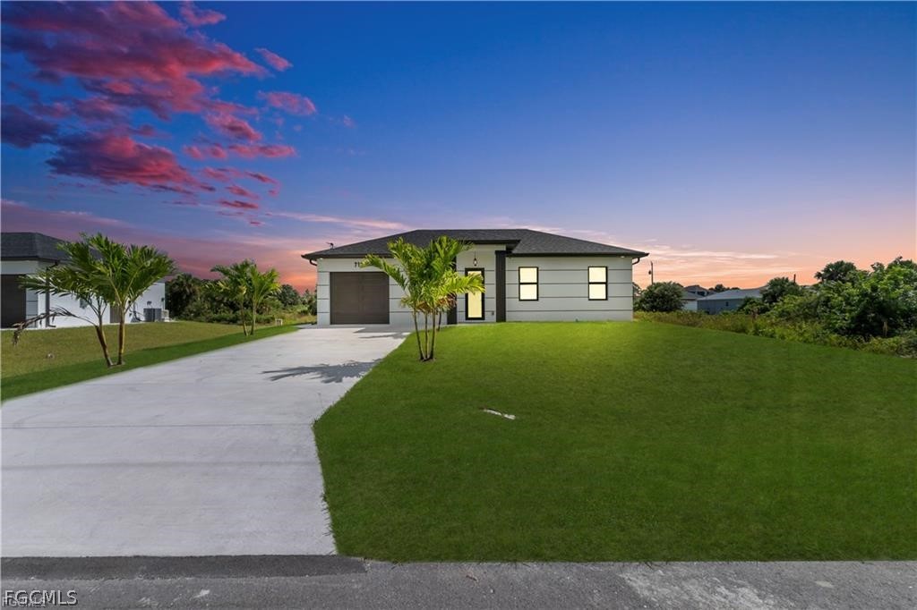 711 Roma Avenue South Lehigh Acres, FL 33974 - Photo 38 of 38 a front view of a house with a garden