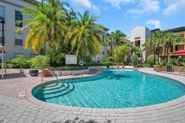 a swimming pool with outdoor seating and yard