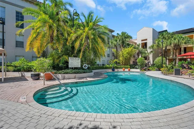 a swimming pool with outdoor seating and yard