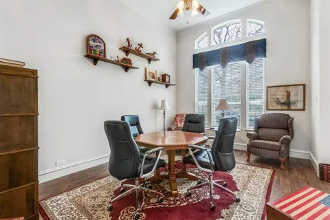 a living room with furniture wooden floor and a table