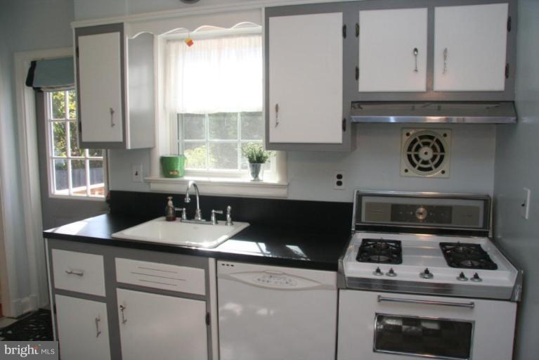 1706 Donald Place Silver Spring, MD 20902 - Photo 8 of 30 a kitchen with a stove and a white cabinets