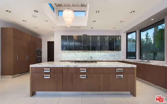 a view with granite countertop a sink and a stove with granite countertops