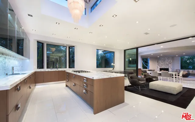 a large white kitchen with a large window